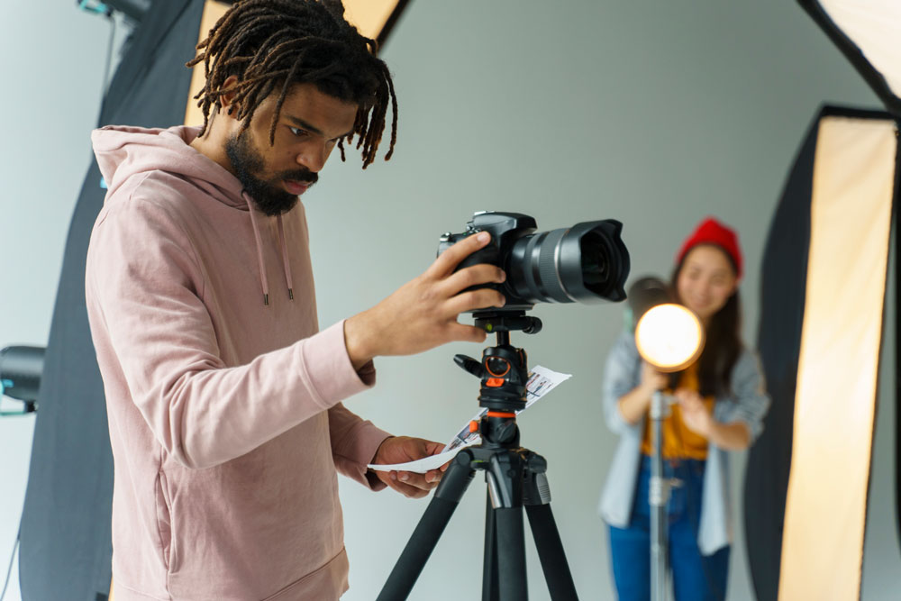 man looking his camera tripod